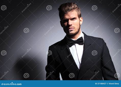 Handsome Man In Tuxedo And Bow Tie In A Dramatic Pose Stock Image