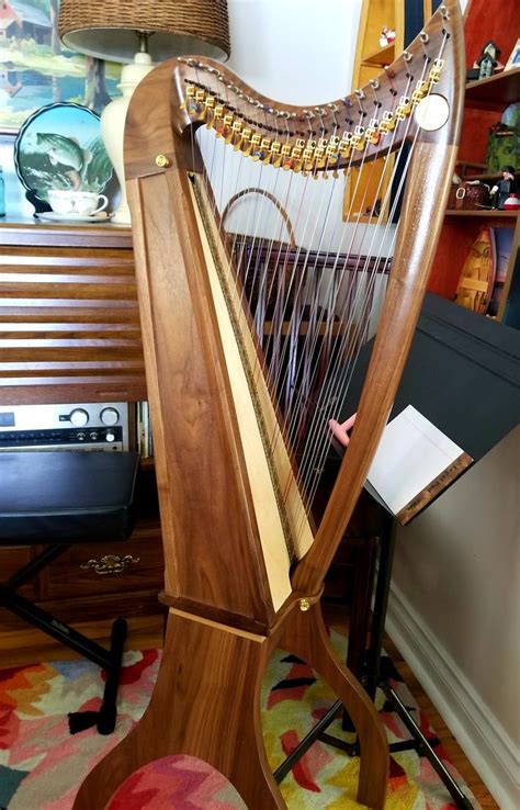 A Large Wooden Harp Sitting On Top Of A Rug