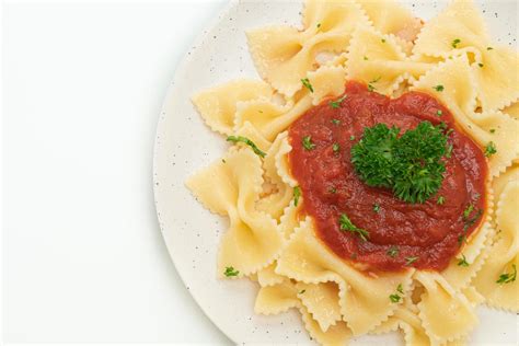 Farfalle pasta in tomato sauce with parsley - Italian food style 2622931 Stock Photo at Vecteezy