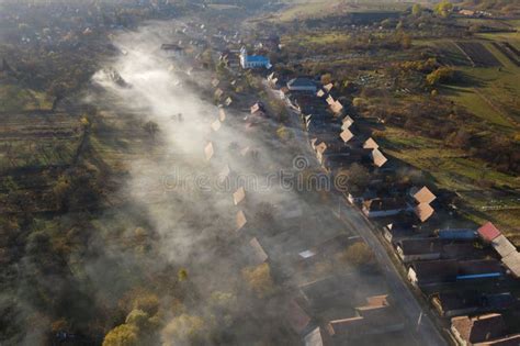 Aerial Drone View Of Morning Haze And Mist Above Village Houses Stock