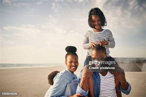 Black Father Carrying Daughter On Shoulders At Beach Photos And Premium