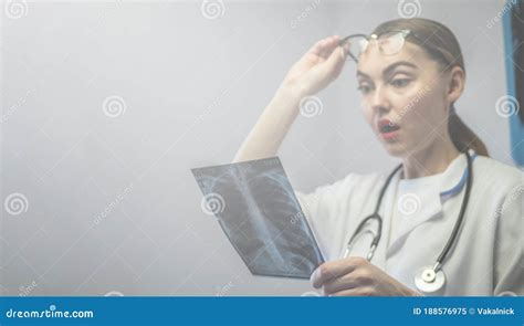 Female Doctor Holding X Ray Of Lungs Fluorography Roentgen In