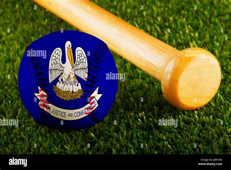 Baseball With Louisiana Flag And Bat Over A Background Of Green Grass