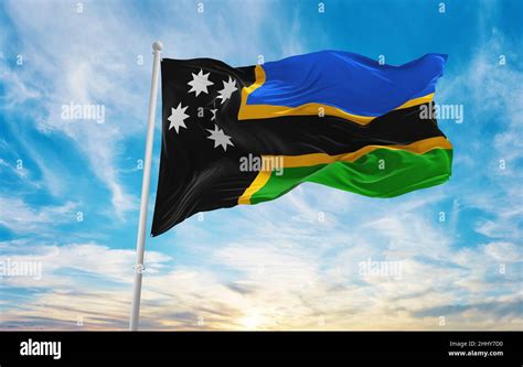 flag of Australian South Sea Islanders , Australia at cloudy sky background on sunset, panoramic ...