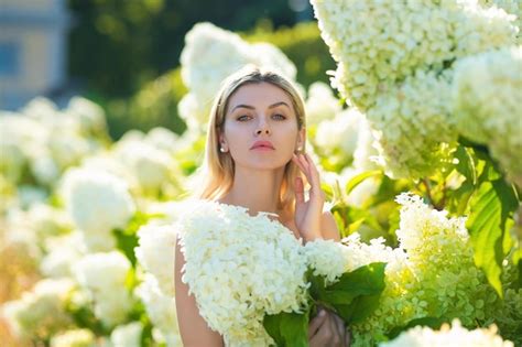 Premium Photo Young Woman In Hydrangea Garden Bushes Of Flowers In