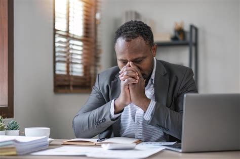 Premium Photo | Tired african business man his with eyes closed sitting ...