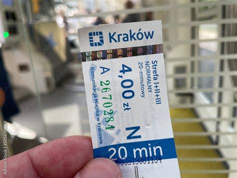 Foto de Hand holding a 20-minute full fare ticket type inside a MPK Kraków public transport tram ...