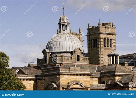 Victorian Building With A Tower And Weather Vane On The Top Of The Roof