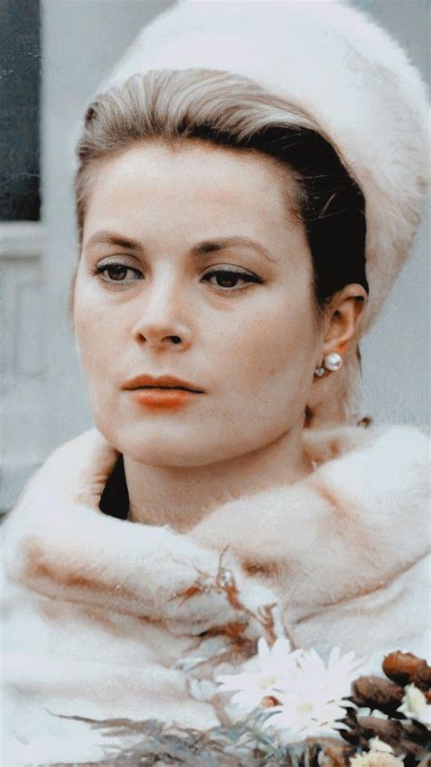 A Woman Wearing A White Hat And Fur Coat