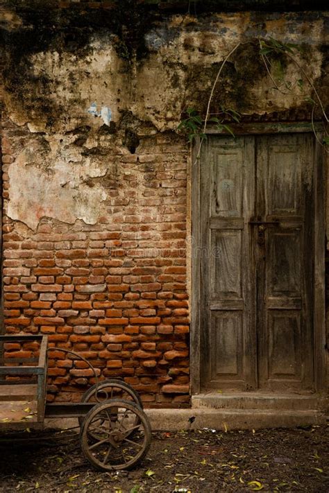 Abandoned Ancient Building With Dark Entrance And Wooden Door Stock