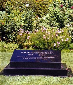 The Headstone Of Richard Nixon Is In Front Of Some Bushes And Flowers