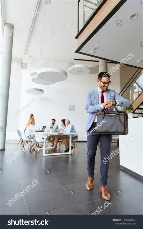 Handsome Businessman Leaving Office Looks Watch Stock Photo 1258390084