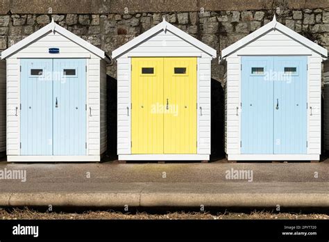 Pastel Coloured Beach Huts On The Sea Front By Front Beach Lyme Regis