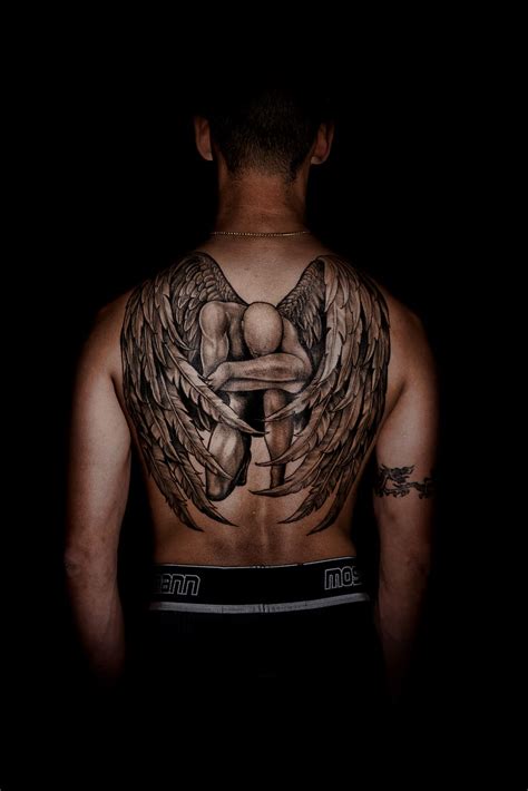 HD wallpaper: person with kneeling angel back tattoo, black background ...