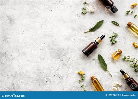 Natural Wellness Essential Oils Near Herbs And Leaves On Light Grey