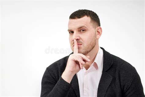 Man Saying Hush And Be Quiet With Finger On Lips Gesture Looking At