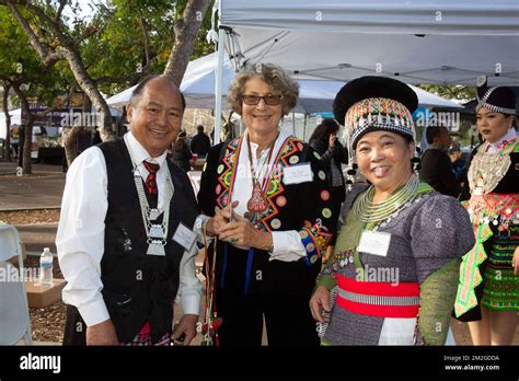 Hmong community leaders pose wth white female cultural advocate at the Hmong New Year ...