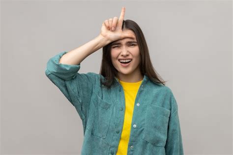 Premium Photo Depressed Woman Showing Loser Gesture L Finger Sign On Forehead Upset About