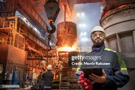 Portrait Of Steelworker During Steel Pour In Steelworks High Res Stock