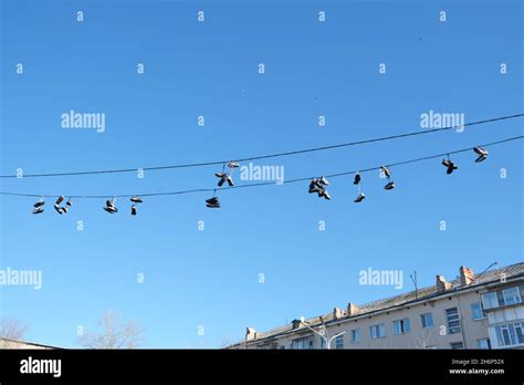 Sports Shoes Are Hanging On Wiressneakers Suspended By Laces On