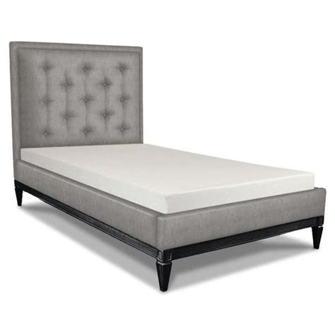 An Upholstered Bed Frame With Buttons On The Headboard And Foot Board