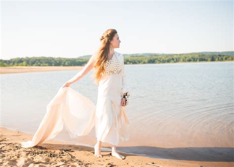 Barefoot Bride Walks Along Beach