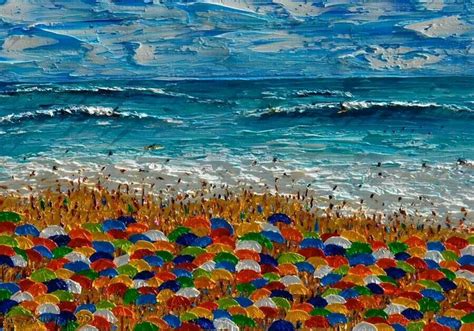 There Are Many Colorful Umbrellas In The Sand By The Ocean And People