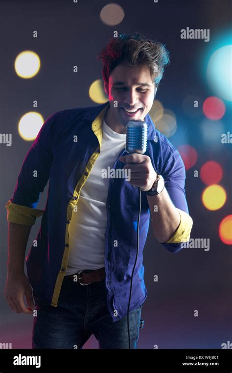 Man Singing Into Microphone And Smiling Stock Photo Alamy