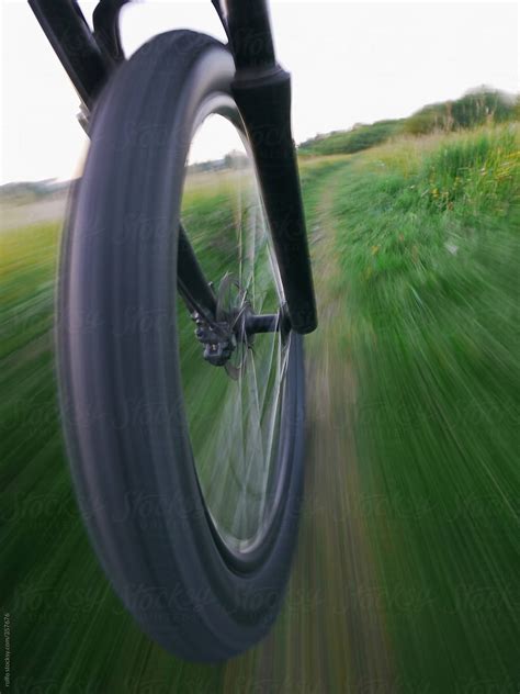 Bike Wheel Motion Blurred Along A Path By Stocksy Contributor Rolfo