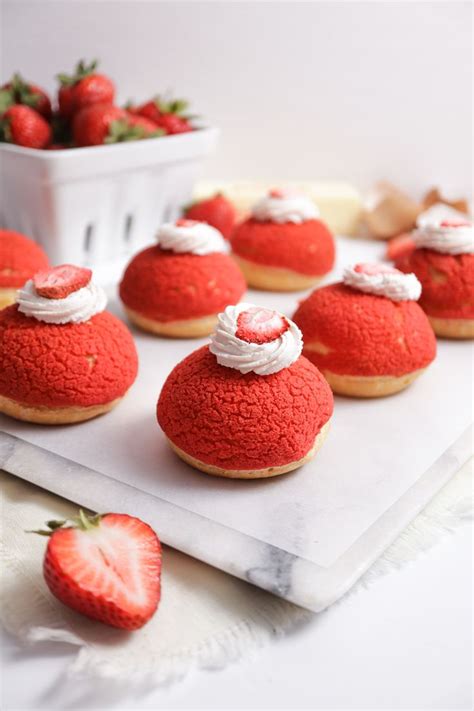 Side View Of Six Choux Au Craquelin On A Rectangle White Marble Tray