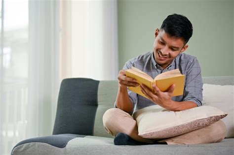 Premium Photo Smart And Happy Millennial Asian Man Relaxing On Sofa In His Living Room Enjoys