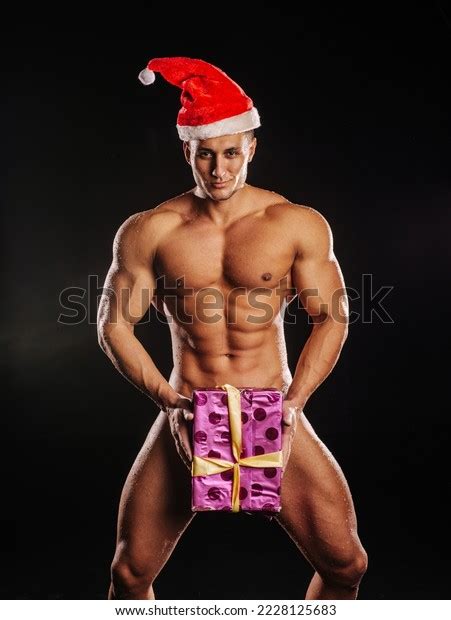 Стоковая фотография 2228125683 Naked Handsome Male Model Santa Hat
