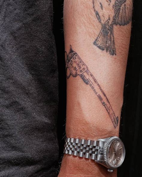 Revolver Tattoo Located On The Forearm