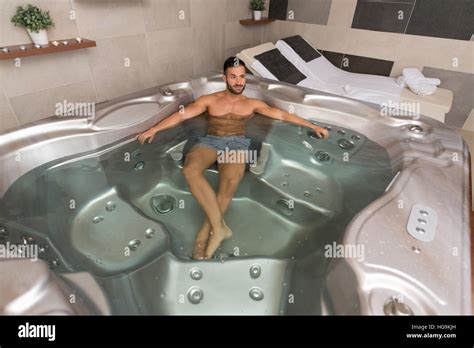 Wellness Spa Man Relaxing In Hot Tub Whirlpool Jacuzzi Indoors At Luxury Resort Spa Retreat