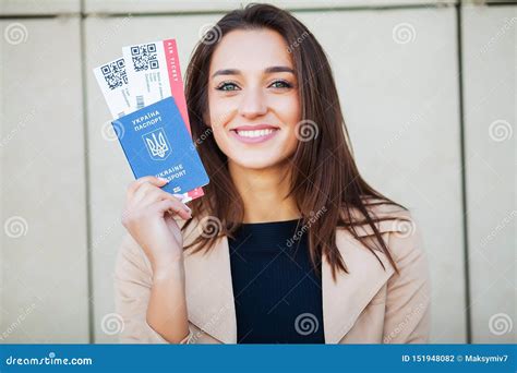 Travel Woman Holding Two Air Ticket In Abroad Passport Near Airport