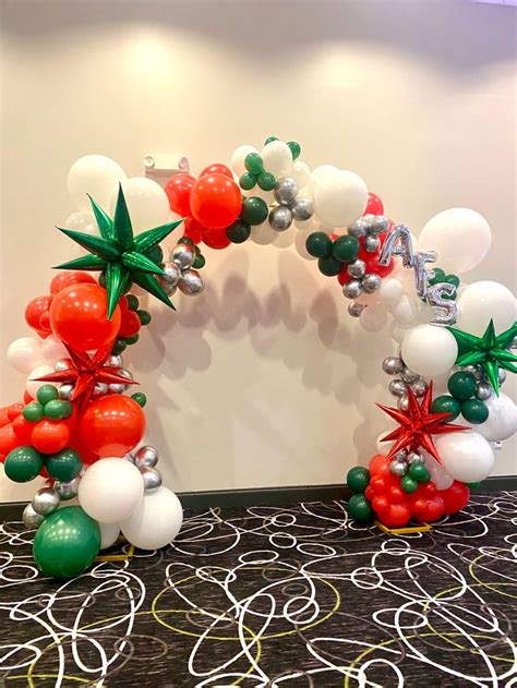 An Arch Made Out Of Balloons And Other Decorations