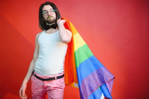 Premium Photo Handsome Young Man With Pride Movement Lgbt Rainbow Flag On Shoulder Against