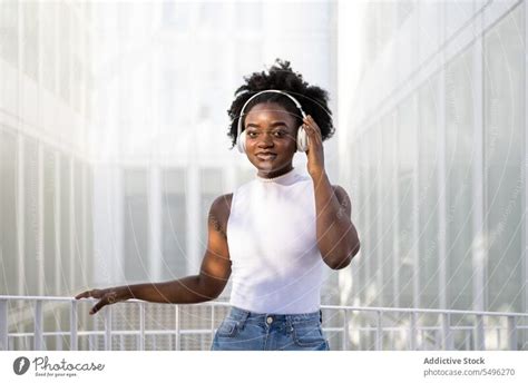 Black teenage girl touching headphones - a Royalty Free Stock Photo ...