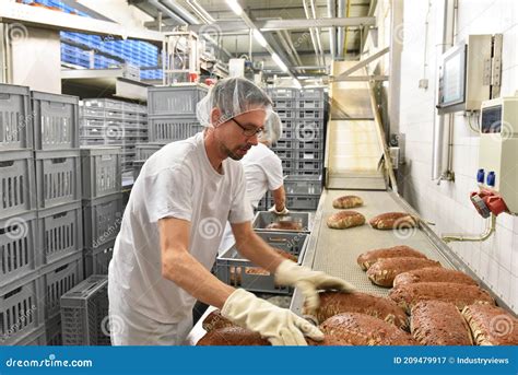 Worker in a Large Bakery - Industrial Production of Bakery Products on ...