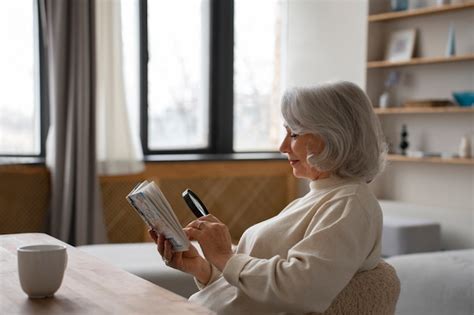 Free Photo Elderly Woman Reading Using A Magnifying Glass To Read