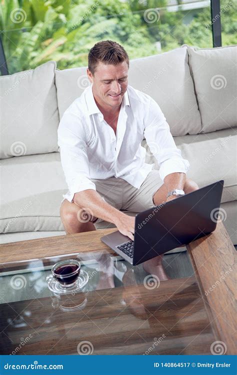 Man On Sofa With Laptop In Summer House Environment Stock Image Image