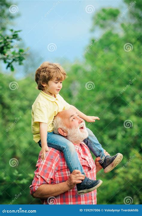 Grandfather And Grandson Playing In The Park At The Day Time Funny