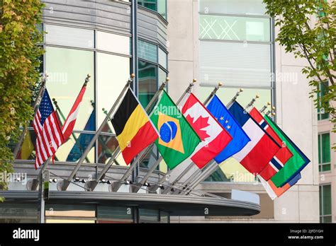 Row Of World Flags From Global Nations Hanging From Short Flag Poles On