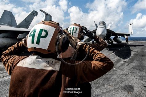 Sailors Signal A Pilot To Test The Vertical Stabilizers Of An F A E