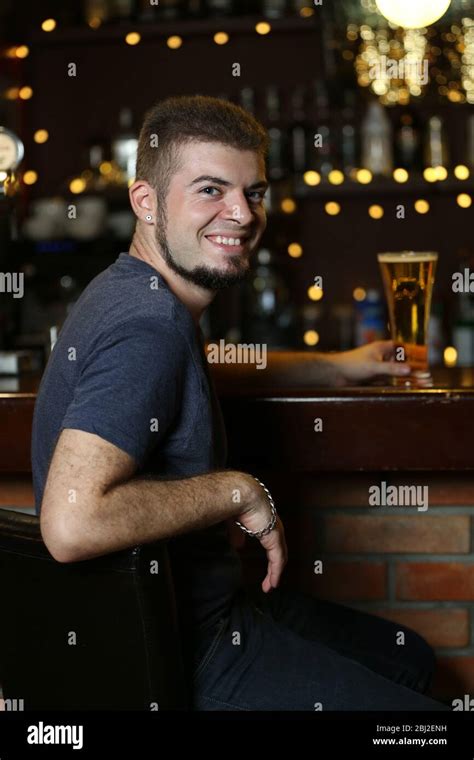 Young Man Drinking Beer In Bar Stock Photo Alamy