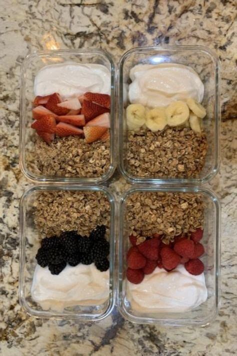 Four Glass Containers Filled With Different Types Of Food On Top Of A