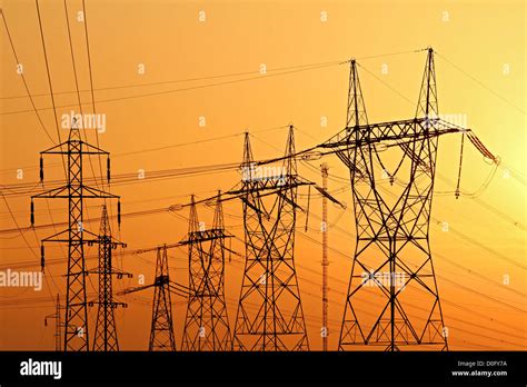 High Voltage Electrical Pylons During Sunset Stock Photo Alamy