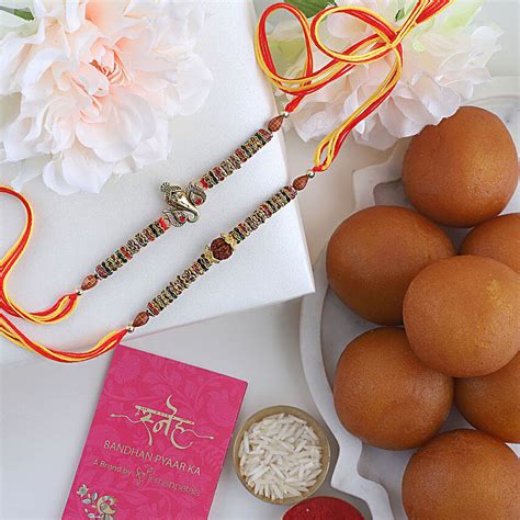 Buy Send Sneh Ganesha Rakhi Set Of 2 With Gulab Jamun Online FNP