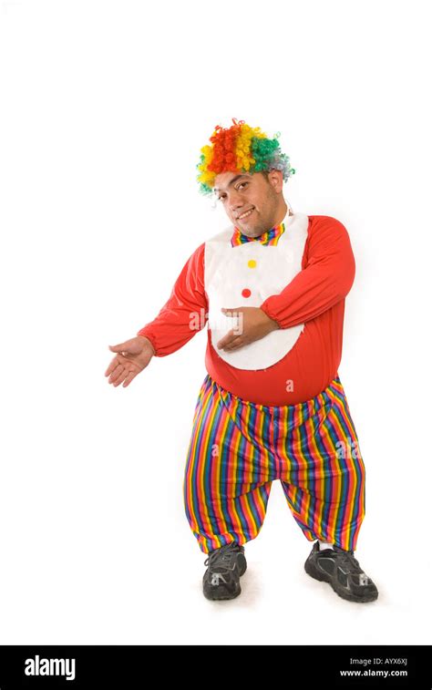 Full Length Portrait Of A Midget Clown Pointing Hands Against A White