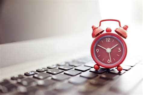 Alarm Clock On Laptop Concept For Business Deadline Schedule And